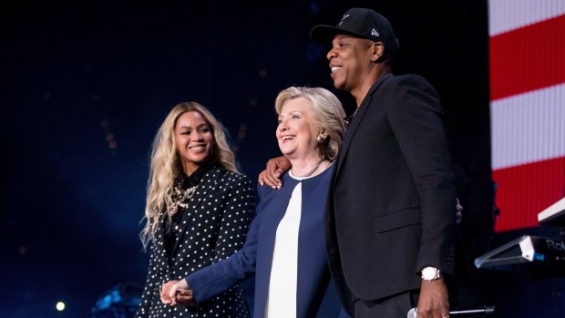 Hillary Clinton appears on stage with artists Jay Z and Beyonce.