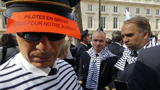 Je refuse: Striking Air France pilots attend a demonstration near the National Assembly in Paris.