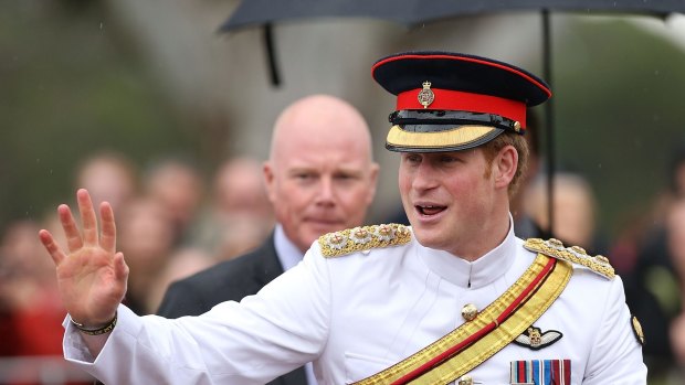 Prince Harry waves to members of the public outside the Australian War Memorial on Monday. 