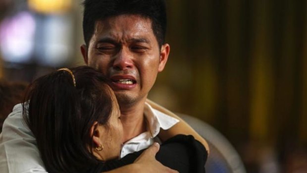 The father of a pair of siblings killed in a Bangkok bomb blast mourns during their funeral.