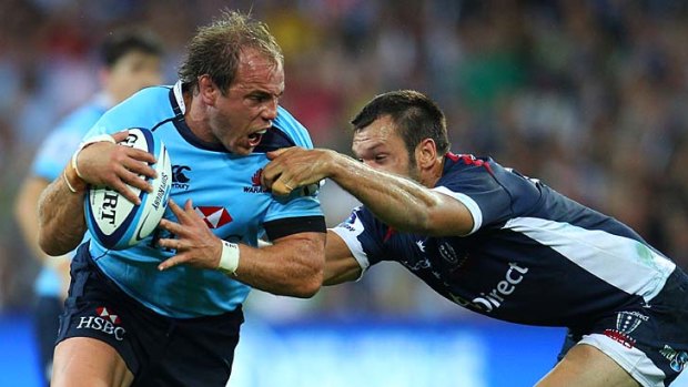Waugh not the answer? ... Waratahs captain Phil Waugh tangles with Melbourne Rebels back Luke Rooney at AAMI Stadium in round one.