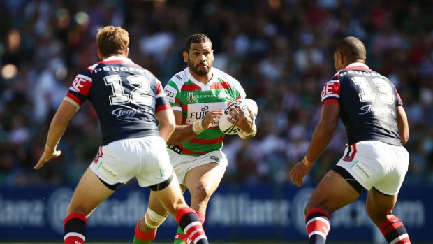 Hard to stop: Greg Inglis takes on the defence during the round one NRL match between the Sydney Roosters and the South Sydney Rabbitohs at Allianz Stadium.