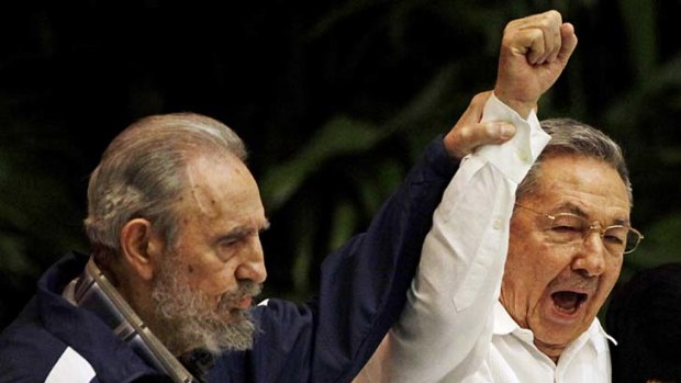 Fidel Castro, left, raises his brother's hand, Cuba's President Raul Castro, April 19, 2011.