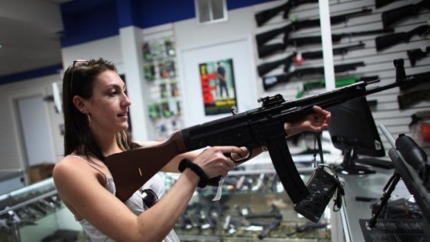 A woman looks at guns on sale in April 2013 at the National Armory gun store in Pompano Beach, Florida.