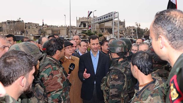 Surrounded by soldiers, President Bashar al-Assad was pictured touring the Baba Amr neighbourhood of Homs in images supplied by the Syrian national news agency SANA.