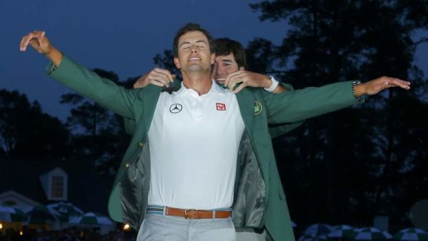 Adam Scott receives his green jacket after winning the 2013 Masters golf tournament at Augusta.