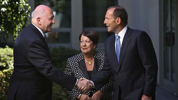 Let's shake on it: General Cosgrove and wife Lynne with Prime Minister Tony Abbott.