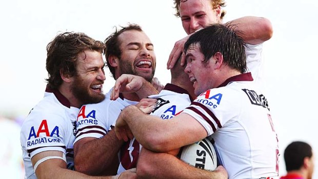 Glenn Stewart celebrates with teammates after his try against the Knights.
