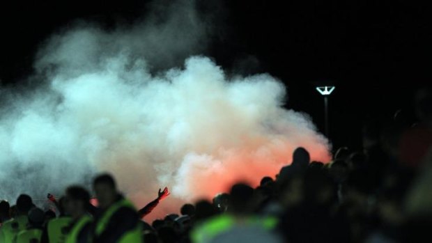 Flares go off during this year's Capital Premier League grand final between Canberra FC and Belconnen United. 