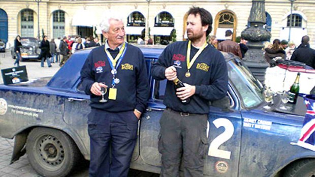 Gerry Crown (left) and his navigator Matt Bryson celebrate their victory in Paris after more than 14,000 kilometres in their 1964 EH Holden.