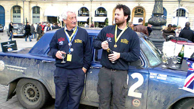 Gerry Crown (left) and his navigator Matt Bryson celebrate their victory in Paris after more than 14,000 kilometres in their 1964 EH Holden.