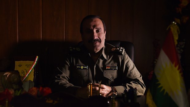 Brigadier-General Sarhad Qadir Muhammad in his office. The flag of Iraq's Kurdistan region can be seen on the right. Iraq's government has in the past disputed Kurdish authority over Kirkuk province.