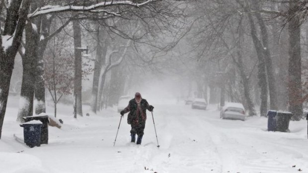 Ray Pass gets a chance to use his cross country skis on a street in University City, St Louis near his home on Sunday morning.