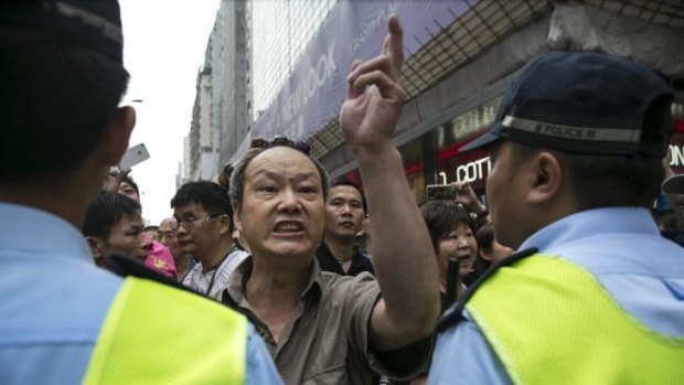 Pro government supporters scuffle with student demonstrators while police control the situation as tensions continue in Mongkok, Kowloon on October 4, 2014 in Hong Kong. 