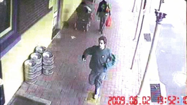 Elijah Holcombe is captured on CCTV running in Armidale on the day he was shot dead.
