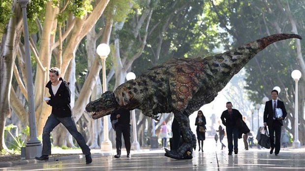 It's alive!: A Tyrannosaurus-rex taking a morning stroll with commuters in Hyde Park.