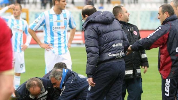 Medics treat Livorno midfielder Piermario Morosini after he suffered a suspected heart attack.