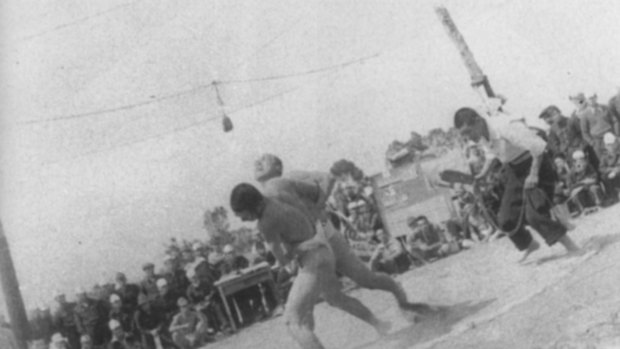 Japanese prisoners of war keep occupied with sumo wrestling.