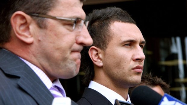 Nervous . . . Quade Cooper, right, outside court yesterday.