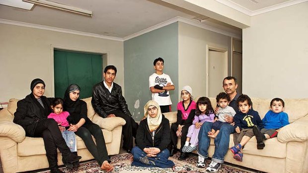 Awad with his children in their barren home in Perth's southern suburbs. Photo: Stefan Gosatti