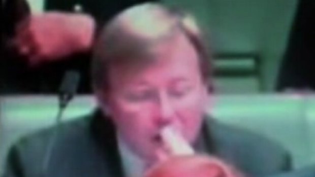 Kevin Rudd at question time allegedly picking his ear wax and eating it. 