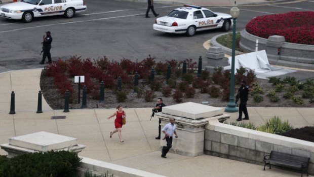 Panic: Pedestrians flee as police respond to reports of shots fired at the US Capitol.