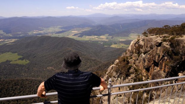 View from the top: A sightseer takes in the spectacular alpine scenery  from  one of the viewing platforms near the Mount Buffalo Chalet.