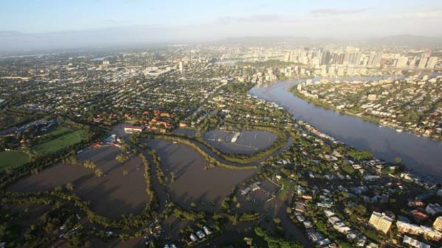 From the air it becomes clear just how much of the city has been taken by the swollen Brisbane River.