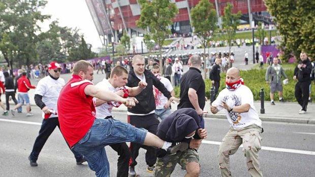 Kick to the head ... fans brawl outside the stadium.