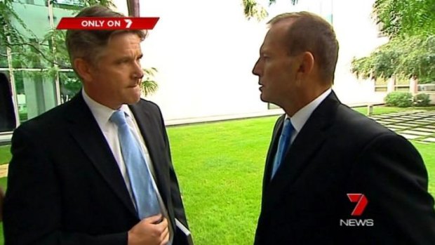 A dramatic pause: Tony Abbott nods at Mark Riley.