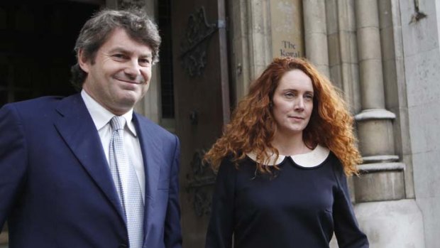 Facing charges ... Rebekah and Charlie Brooks leave the High Court in London.