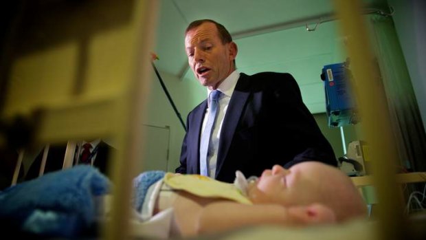 Four-month-old Henry Brown has a visit from Liberal leader Tony Abbott before  at the Royal Childrens Hospital in Melbourne.