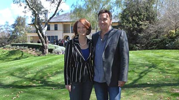Julia Gillard and Tim Mathieson take a stroll around The Lodge's gardens.