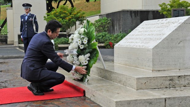 Japanese Prime Minister Shinzo Abe visits the National Memorial Cemetery of the Pacific to place a wreath at the Honolulu Memorial on Monday, 