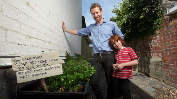 Caring and sharing: HerbShare founder Ben Hart and his son Oscar, 8, check out their herb crop in the lane behind their house.