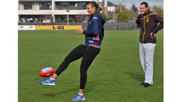 Melbourne Vixens' Geva Mentor shows off her kicking style as Jarryd Roughead looks on.