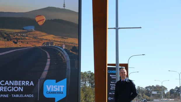 ACT Chief Minister Andrew Barr with one of the new Welcome to Canberra signs.