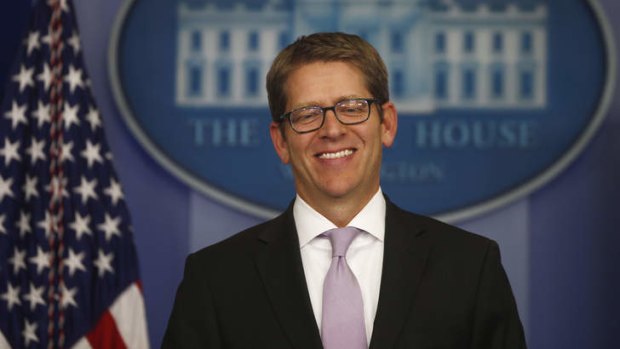 White House Press Secretary Jay Carney smiles as he arrives for the daily press briefing after the deal was struck.