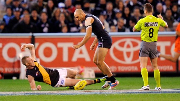 Jack on his back ... Carlton's Chris Judd pushes over Richmond's Jack Riewoldt and reverses the free kick.