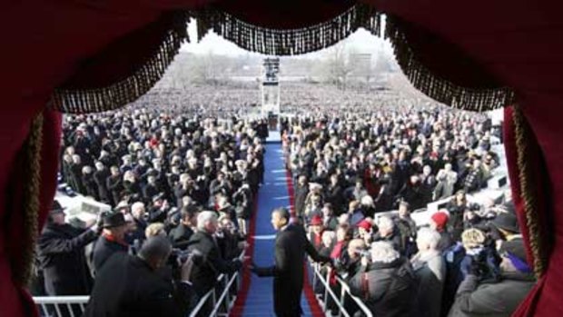 Barack Obama, the first black president of the United States, arrives at his inauguration on the West Front of the Capitol in Washington. The amassed crowd extends as far as the eye can see.