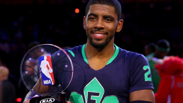 The Eastern Conference's Kyrie Irving of the Cleveland Cavaliers celebrates with the NBA All-Star Game MVP trophy at the Smoothie King Center in New Orleans.