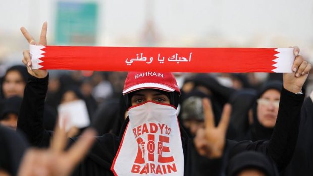 An anti-government protester participates in a march held by Bahrain's main opposition party Al Wefaq in the village of Karzakan.