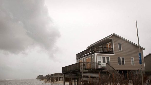 Tide rolls up under a home as wind, rain and tidal surge from Hurricane Irene begin to be felt along the Outer Banks in Nags Head, North Carolina.