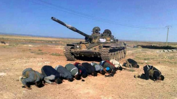 Syrian rebels praying in front their tank, at al Mutayia village, in the southern province of Daraa. The Obama administration has indicated it might support the rebels with weaponry in the upcoming months.