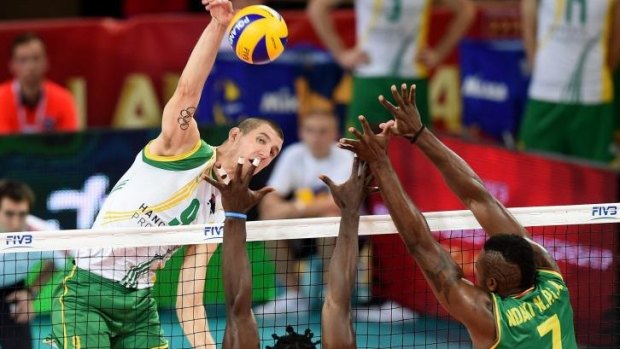 Adam White of Australia spikes the ball during the win over Cameroon.