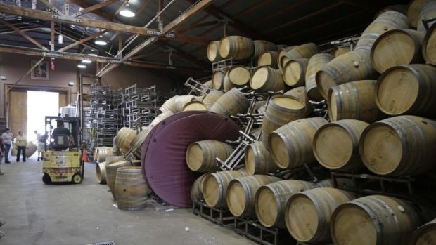 Cellar workers continue the clean-up after a number of barrels toppled following an earthquake at the Saintsbury winery.