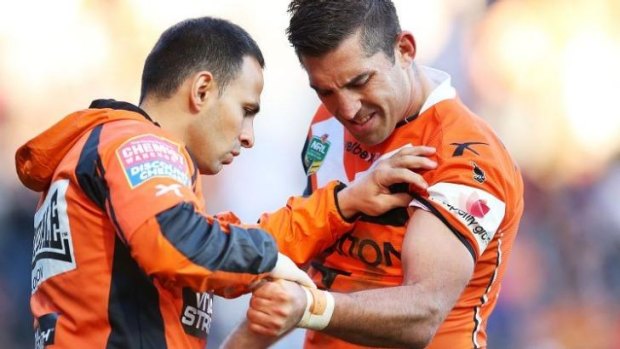 Tough times: Braith Anasta is attended to by a Tigers trainer on Sunday