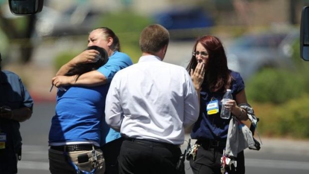Walmart employees hug outside their store after shootings left five people dead at the store and a nearby pizzeria in Las Vegas.