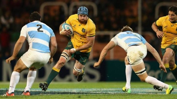 Back in the fold: James Horwill takes on the Argentina defence.