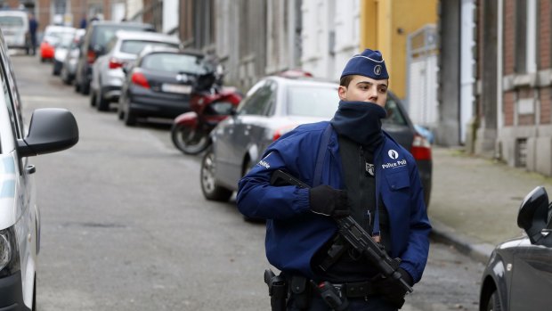 Belgian police block off the street outside an apartment in central Verviers, a town between Liege and the German border, in the east of Belgium.
